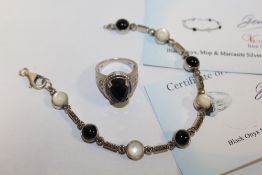 A BLACK ONYX AND SILVER DRESS RING TOGETHER WITH A SIMILAR BRACELET WITH CERTIFICATES