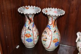 A PAIR OF ORIENTAL BALUSTER VASES WITH FRILLED RIMS, each vase decorated with a figure in a shaped