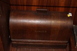 A VINTAGE OAK CASED SINGER SEWING MACHINE