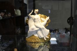 A GILT AND MATTE FINISH MINTON FIGURE 'AMPHITRITE AND THE DOLPHIN' NO 525