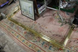 A LARGE MODERN BRASS EFFECT FENDER, W 182 cm