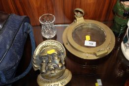 A VINTAGE BRASS PORT HOLE, TOGETHER WITH A BRASS HENRY VIII SHAPED DOOR KNOCKER