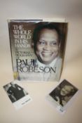 A SIGNED PHOTOGRAPH OF PAUL ROBESON, TOGETHER WITH ANOTHER AND HIS PICTORIAL BIOGRAPHY (3)