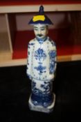 AN ORIENTAL BLUE AND WHITE FIGURE WITH IMPRESSED STAMPS TO BASE