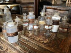 A COLLECTION OF TEN LATE 19TH / EARLY 20TH CENTURY GLASS APOTHECARY / CHEMISTS BOTTLES, ALL WITH