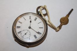 A SMALL ANTIQUE SILVER POCKET WATCH WITH KEY