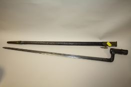 AN ANTIQUE BAYONET IN LEATHER AND BRASS SHEATH