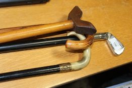 FIVE ASSORTED WALKING STICKS TO INCLUDE A YELLOW METAL BANDED EXAMPLE, MODERN GOLF INTEREST