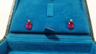 A PAIR OF 18 CT WHITE GOLD RUBY AND DIAMOND STUDS WITH RUBBERISED BUTTERFLIES, OVAL CUT RUBIES 2.