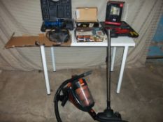 A VAX CYCLONE VAC TOGETHER WITH A BOXED SECURITY LIGHT AND A DRILL