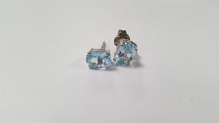 A PAIR OF BLUE TOPAZ SILVER STUDS