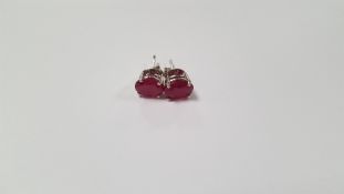 A PAIR OF TREATED RUBY SILVER STUDS