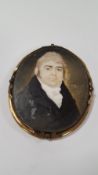 A GEORGIAN MINIATURE OF A GENTLEMAN IN GILT METAL FRAME
