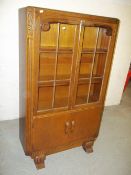 AN OAK GLAZED BOOKCASE