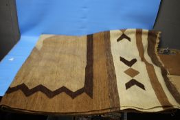 A VINTAGE BROWN AND CREAM KILIM RUG