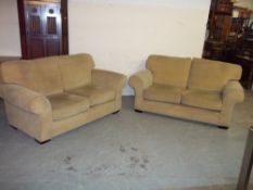 A FABRIC TWO PIECE SUITE COMPRISING TWO TWO SEATER SOFAS