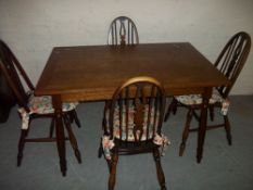 AN OAK DINING TABLE AND FOUR CHAIRS