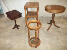FOUR ITEMS INCLUDING AN ANTIQUE UMBRELLA STAND, A DRUM TABLE AND A SEWING TABLE / TROLLEY