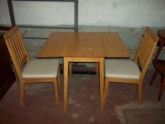 A SMALL SQUARE KITCHEN TABLE AND TWO CHAIRS