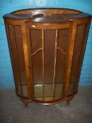 A WALNUT BOW FRONTED CHINA CABINET