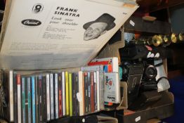 A TRAY OF ASSORTED CAMERAS AND A COLLECTION OF CDS AND RECORDS