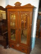 AN ANTIQUE OAK WARDROBE