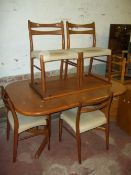 AN OAK EXTENDING DINING TABLE WITH FOUR CHAIRS