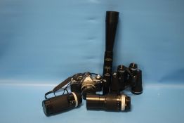 A CANNON AE-1 CAMERA, A PAIR OF BINOCULARS, TWO CAMERA LENSES ETC.