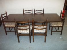 AM EXTENDING OAK DINING TABLE AND SIX CHAIRS
