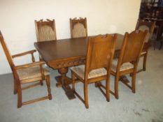 A LARGE OAK DRAW LEAF DINING TABLE AND SIX CHAIRS