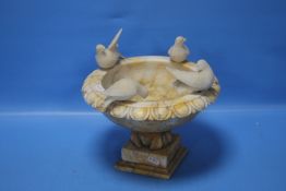 AN ALABASTER BIRD BATH ORNAMENT