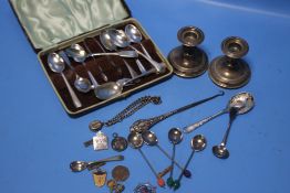 A PAIR OF SILVER DWARF CANDLESTICKS WITH LOADED BASES AND A BOX OF SILVER SPOONS ETC.