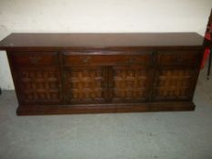 A HEAVY OAK PANELLED SIDEBOARD