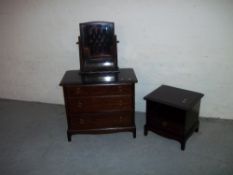 A STAG MINSTREL THREE DRAWER CHEST, A BEDSIDE CHEST AND A SWIVEL MIRROR