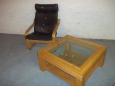 A BROWN LEATHER IKEA POANG CHAIR AND AN OAK COFFEE TABLE