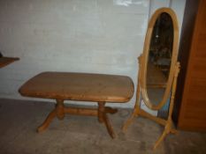 A PINE SWIVEL DRESSING MIRROR AND A LARGE PINE COFFEE TABLE