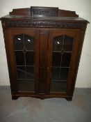 AN OAK CHINA DISPLAY CABINET / BOOKCASE