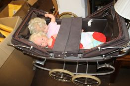 A TWIN DOLLS PRAM WITH DOLLS