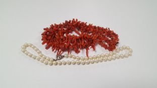 A PEARL NECKLACE WITH SILVER CLASP ALONG WITH A STICK CORAL NECKLACE