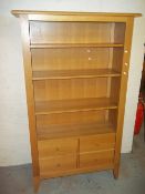 A MODERN LIGHT OAK BOOKCASE DISPLAY WALL UNIT WITH STORAGE DRAWERS