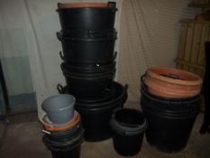 A LARGE QUANTITY OF BUCKETS AND LARGE GARDEN PLANTERS