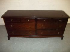 A STAG MINSTREL LOW WIDE EIGHT DRAWER CHEST OF DRAWERS
