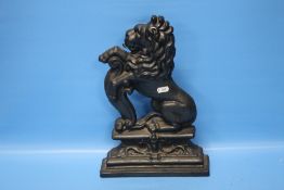 A CAST DOOR STOP IN THE FORM OF A LION