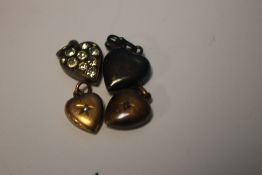 FOUR ANTIQUE HEART SHAPED CHARMS, ONE MARKED 15 CT