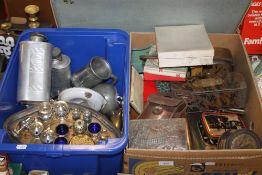 TWO TRAYS OF METALWARE ETC. TO INCLUDE CRUETS, FLASKS ETC. TOGETHER WITH A WICKER LAUNDRY BASKET(