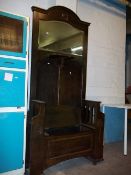 AN ANTIQUE OAK HALL STAND WITH BENCH AND STORAGE