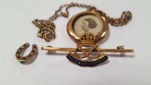A 9 CT GOLD SOUTH STAFFORDSHIRE REGIMENT BROOCH AND A YELLOW METAL LOCKET AND CHAIN, TOGETHER WITH A
