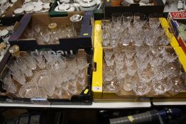FOUR TRAYS OF ASSORTED CRYSTAL DRINKING GLASSES AND DECANTERS ETC.