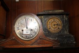 AN OAK CASED NAPOLEON HAT MANTEL CLOCK TOGETHER WITH A SLATE EFFECT WOODEN EXAMPLE