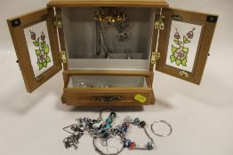 A JEWELLERY CABINET CONTAINING SILVER AND WHITE METAL JEWELLERY